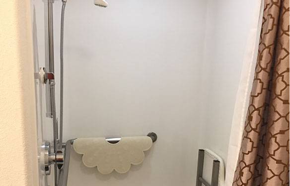 Our accessible king suite is equipped with a roll in shower with a fold down seat and a handheld shower head.